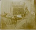 Original title:  Image courtesy of Esther Clark Wright Archives, Vaughan Memorial Library, Acadia University, Wolfville, Nova Scotia. 
Photograph of John Frederic reading and Minnie lying in a hammock, in their library. Date Created: [1900?].