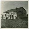 Original title:  Rev. and Mrs. Egerton Ryerson Steinhauer with the Superintendent of Indian Missions in front of the old school house, Morley, Alta. Indian Residential School History & Dialogue Centre Collections. United Church of Canada Archives. 