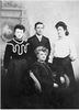 Original title:  Studio portrait of Mrs. Grace Fletcher (seated) with (Left to right) her daughter Nina Fletcher (later Mrs. W.K. McLean), her son Bernard Grant Dewitt Fletcher, and her sister Ally or Allie Fletcher Thompson. Saskatoon Public Library. ID Number LH-1850. 