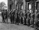 Original title:  H.M.King George VI with Lt.Cols. D.J. Mingay, E.A. Cote and Gen. H.D.G. Crerar inspecting officers at 3rd Canadian Infantry Division Headquarters. (L-R): Maj. Lovering, Capt. Black, -, Capt. Sinkewicz,Lt. Asquith, Maj. Wickwire. 