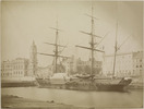 Original title:  Sailboat at wharf. Custom House in background. 