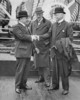Original title:  Rt. Hon. W.L. Mackenzie King and Sir George MacLaren Brown being greeted by Hon. Peter Larkin aboard S.S. MONTCALM en route to the Imperial Conference at London. 