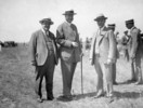Original title:  [Sir Henry Thornton (centre) on the edge of the flying field, near the Ottawa Hunt Club, awaiting Charles Lindbergh's arrival for the Jubilee Celebrations]. 