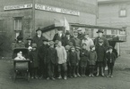 Original title:    DescriptionVisit of Governor Samuel W. McCall of Massachusetts to Halifax, Nova Scotia, Canada, 8 November, 1918.jpg English: Visit of Governor Samuel W. McCall of Massachusetts to Halifax, November 8-10, 1918. During his brief sojourn in Halifax, Governor McCall was photographed with children and several members of the Relief Committee. The Morning Chronicle, of November 9, 1918, reported this event: "The stop at the Exhibition grounds was brief. Governor McCall inspected one of the apartments that bear his name, on Massachusetts Avenue. A photograph was taken of the party in front of this building, and the Governor, always a lover of children, called upon some kiddies, who were playing in the vicinity, to group themselves in the foreground." The adults (left to right) are Mr. Horrigan[?], the Governor's body-guard; Governor McCall; G. Fred Pearson; Captain Hathaway, the Govern