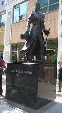 Original title:  Alexander Wood (merchant) - Wikipedia. Statue of Alexander Wood at the corner of Church and Alexander streets in Toronto - photo by user Bearcat (https://en.wikipedia.org/wiki/Alexander_Wood_(merchant)#/media/File:Alexander_Wood_Statue_2005.jpg). Used under 
Creative Commons Attribution-ShareAlike 3.0 Unported (CC BY-SA 3.0) https://creativecommons.org/licenses/by-sa/3.0/. 
