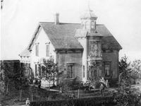 Original title:  Fig. 12A. "Ocean View," the residence of Thomas McMurray, with Mr. and Mrs. McMurray on the front lawn. Image courtesy of Yarmouth County Museum and Archives. (PH-32-MacMurray-1B, YCMA)