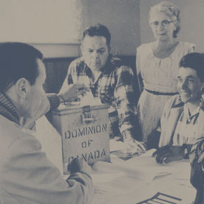 Original title:  Photograph of election officers at Hiawatha Council Hall, near Rice Lake, Ontario, during the first federal election in which all adult aboriginal people in Canada could exercise their right to vote (from left to right: Lawrence Salleby, Chief Ralph Loucks, Lucy Musgrove, Eldon Muskrat), October 31, 1960